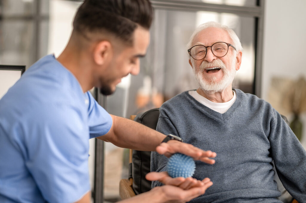An international student in Perth providing aged care to an old man after competition of an aged care course.