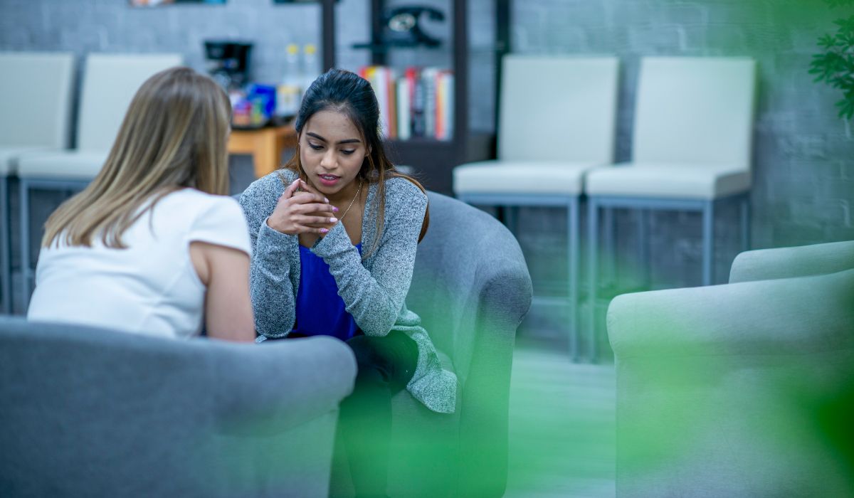 An office setting where two colleagues are discussing matters